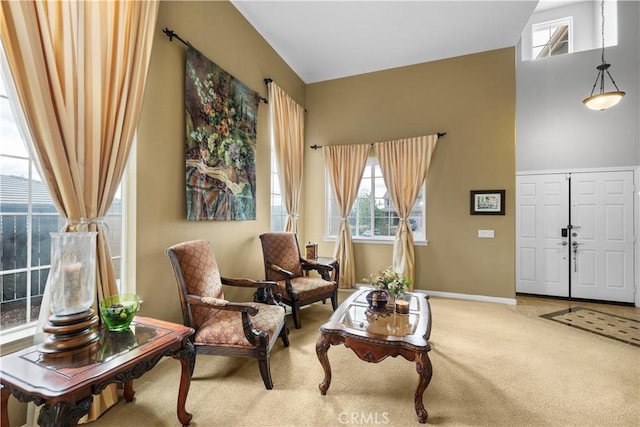 living area featuring carpet floors and baseboards