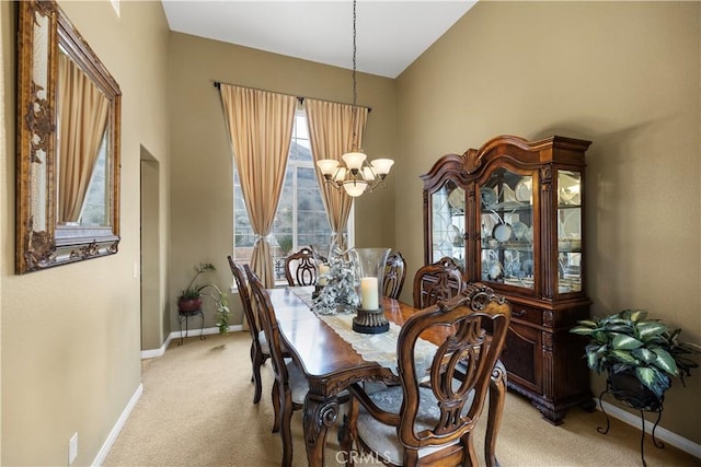 dining space featuring light carpet, baseboards, and a notable chandelier