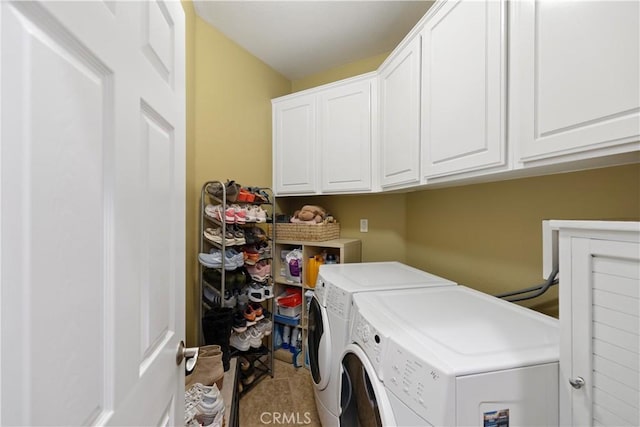 washroom with cabinet space and washer and dryer