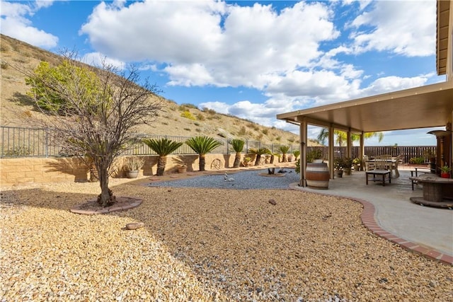 view of property's community featuring an outdoor fire pit, a patio area, and a fenced backyard