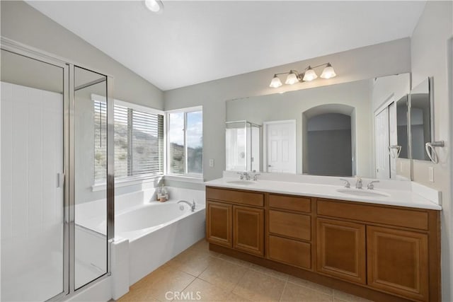 full bathroom with tile patterned flooring, a garden tub, a sink, and a shower stall