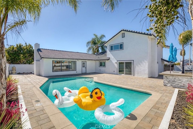 view of swimming pool with a fenced in pool, a fenced backyard, and a patio