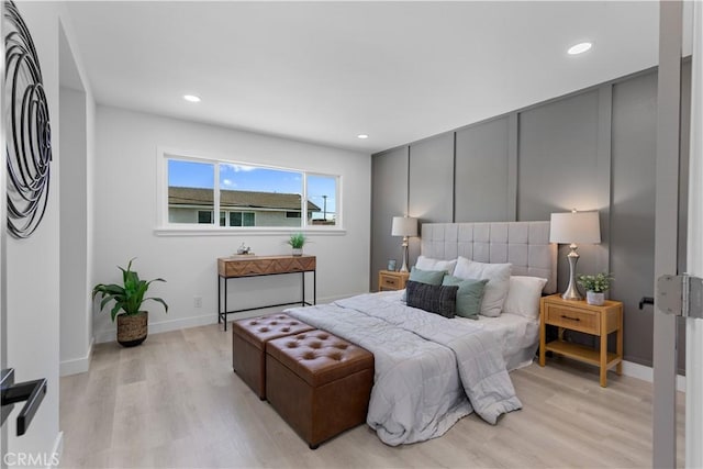 bedroom with light wood-type flooring, baseboards, and recessed lighting