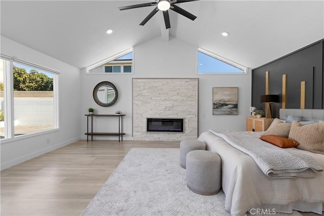 bedroom featuring beam ceiling, a fireplace, light wood-style flooring, high vaulted ceiling, and baseboards