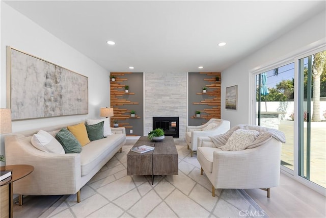 living area with a tile fireplace and recessed lighting