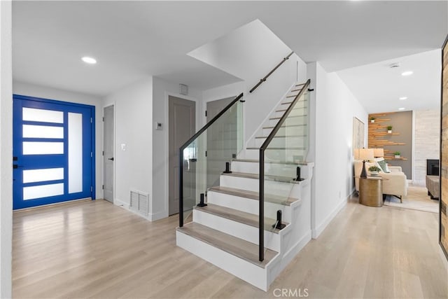 entrance foyer featuring recessed lighting, visible vents, wood finished floors, baseboards, and stairs