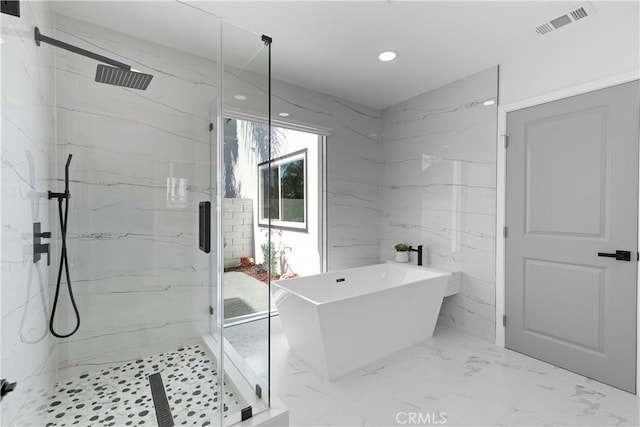 full bath featuring a marble finish shower, visible vents, marble finish floor, a freestanding bath, and recessed lighting