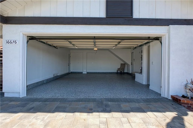 garage with decorative driveway