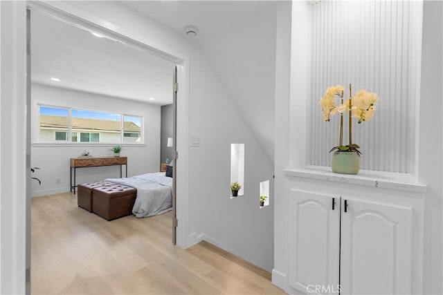 bedroom with light wood-type flooring, baseboards, and recessed lighting