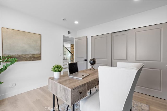 home office with light wood-style flooring, visible vents, and recessed lighting