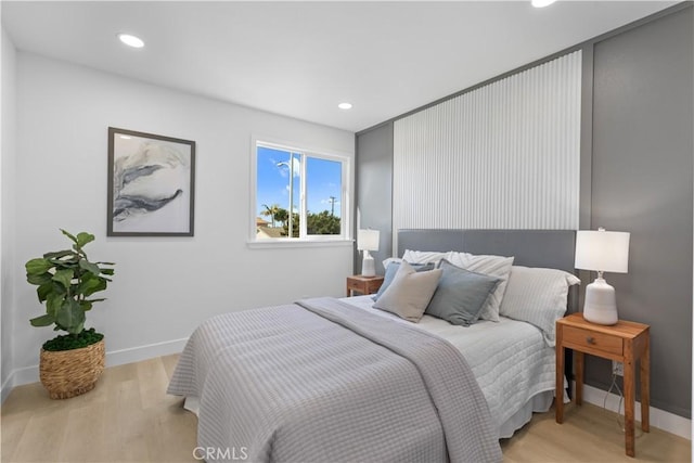 bedroom with recessed lighting, light wood-style flooring, and baseboards