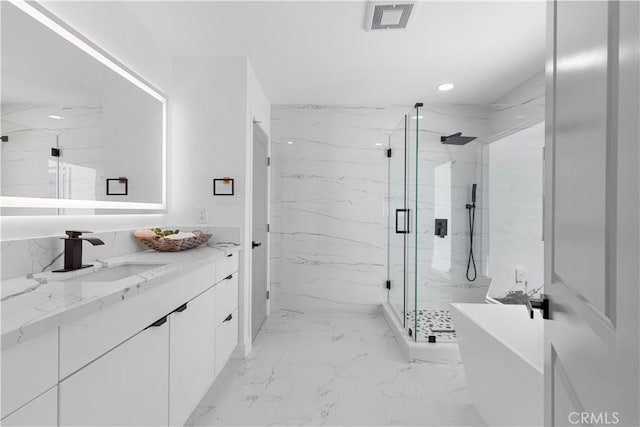 full bathroom featuring a freestanding tub, vanity, visible vents, marble finish floor, and a marble finish shower