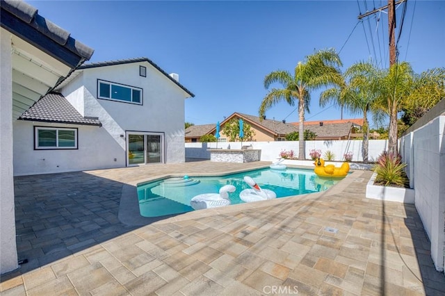 view of swimming pool with a fenced backyard, a fenced in pool, and a patio