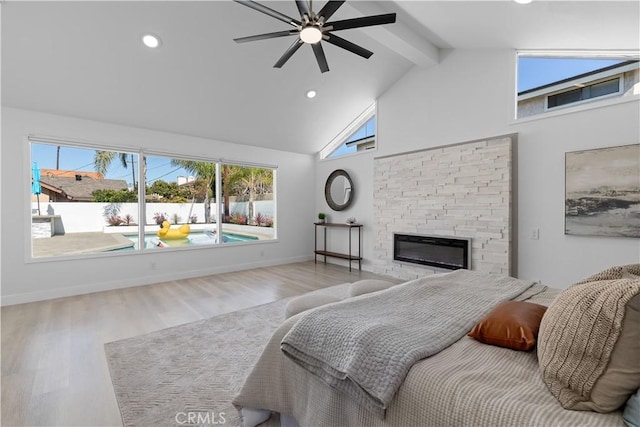 bedroom with a stone fireplace, wood finished floors, high vaulted ceiling, beamed ceiling, and baseboards