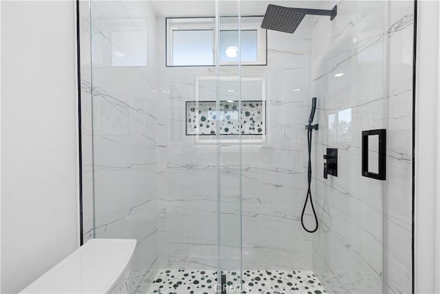 full bathroom featuring a marble finish shower