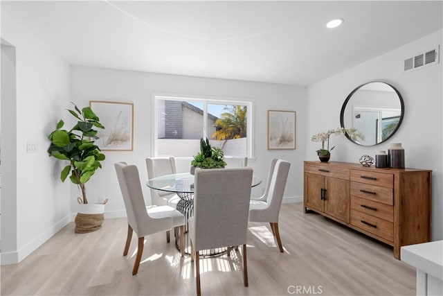 dining space with baseboards, recessed lighting, visible vents, and light wood-style floors