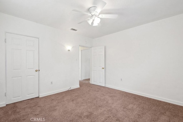 unfurnished bedroom featuring visible vents, baseboards, ceiling fan, and carpet flooring