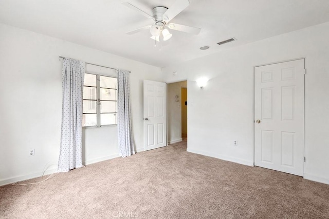 unfurnished room with visible vents, baseboards, ceiling fan, and carpet flooring