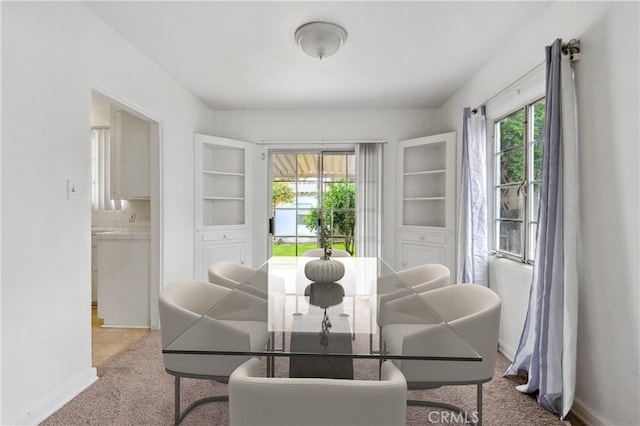 dining room featuring baseboards and carpet floors