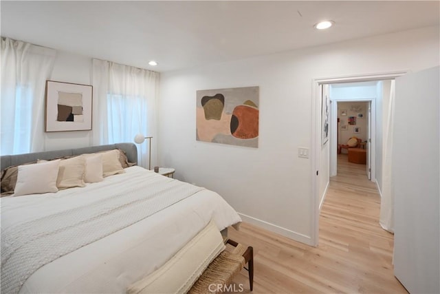 bedroom featuring light wood-type flooring, baseboards, and recessed lighting