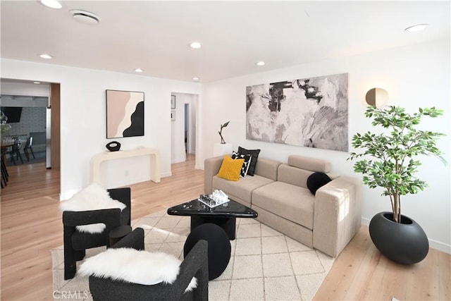 living area featuring light wood-style floors and recessed lighting