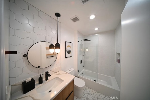 bathroom with tasteful backsplash, visible vents, vanity, and toilet