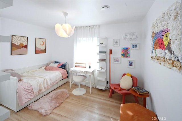 bedroom with wood finished floors