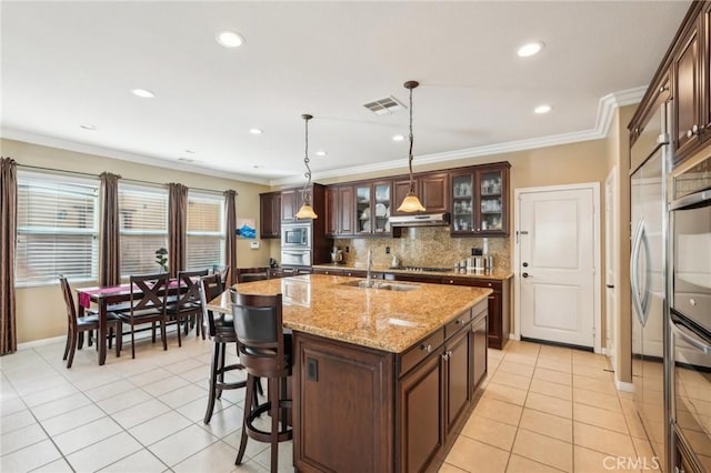 kitchen with visible vents, backsplash, appliances with stainless steel finishes, and ornamental molding