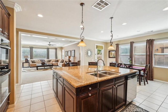 kitchen featuring visible vents, ornamental molding, a sink, stainless steel dishwasher, and light tile patterned floors