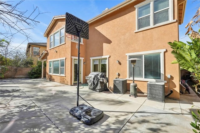 back of house featuring stucco siding, a patio, cooling unit, and fence