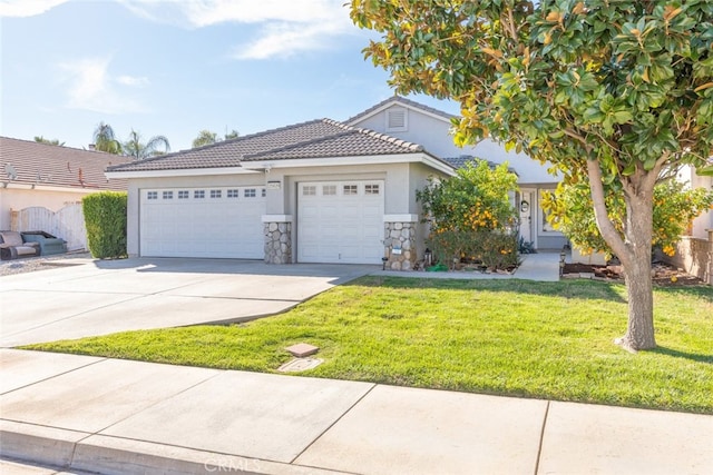 view of front of house with concrete driveway, stone siding, a tiled roof, an attached garage, and a front yard