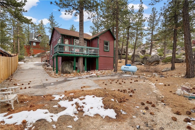 back of property featuring stairs and a wooden deck