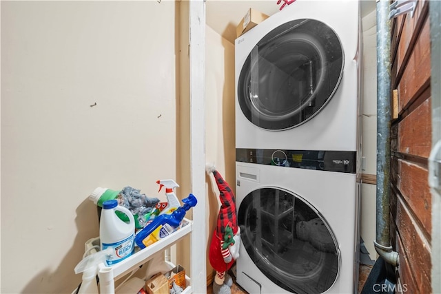 laundry room featuring stacked washer and clothes dryer and laundry area