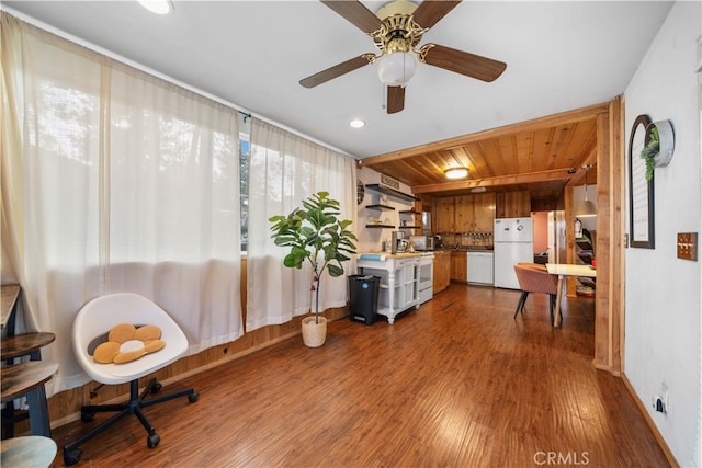 sitting room featuring dark wood-type flooring and baseboards