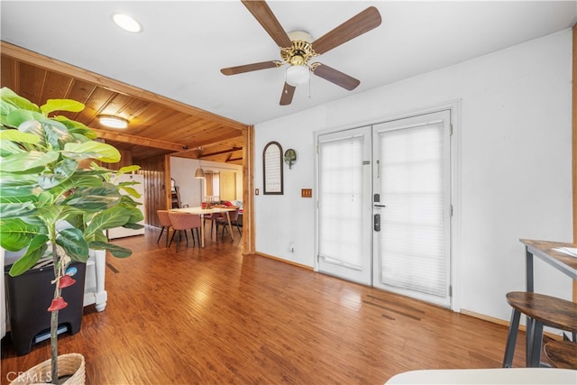 entryway featuring wood finished floors, a ceiling fan, and baseboards