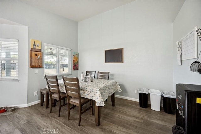 dining room featuring wood finished floors and baseboards