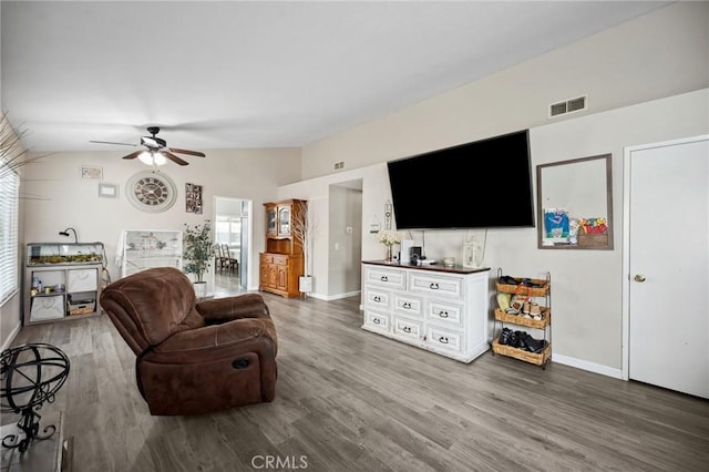 living room with lofted ceiling, wood finished floors, visible vents, and baseboards