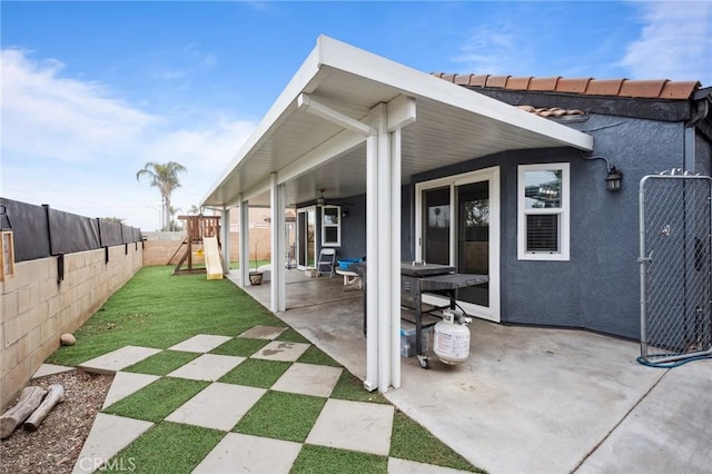 view of patio / terrace featuring a playground and a fenced backyard