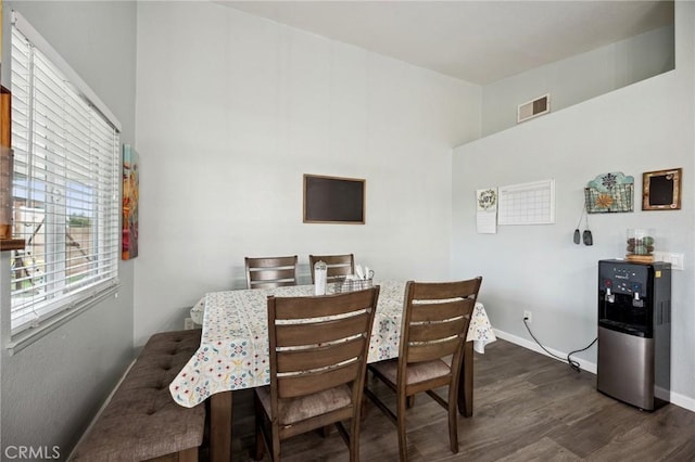 dining area with dark wood-style floors, baseboards, and visible vents