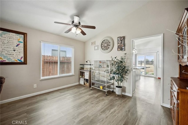 misc room featuring lofted ceiling, a ceiling fan, baseboards, and wood finished floors