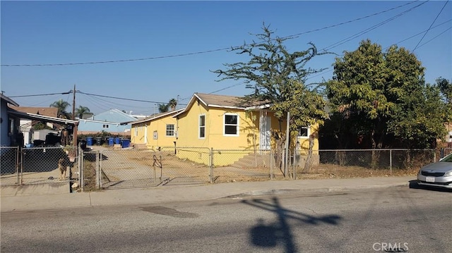 view of front of home with a fenced front yard, a carport, and stucco siding