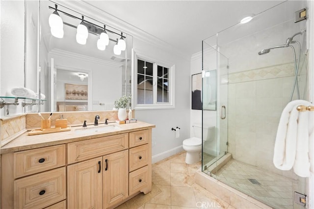 bathroom featuring crown molding, toilet, a stall shower, vanity, and baseboards