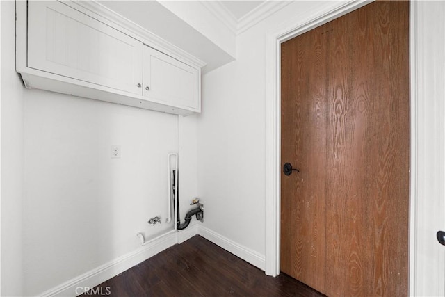 clothes washing area featuring cabinet space, baseboards, hookup for a gas dryer, ornamental molding, and dark wood-style flooring