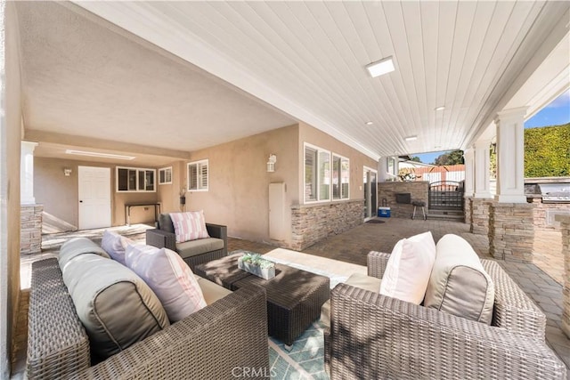 view of patio featuring exterior kitchen, fence, an outdoor living space, and grilling area