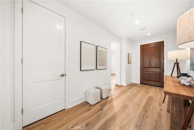 foyer entrance featuring light wood-style floors, recessed lighting, and baseboards