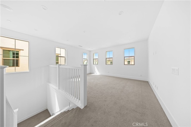 empty room with carpet flooring and baseboards