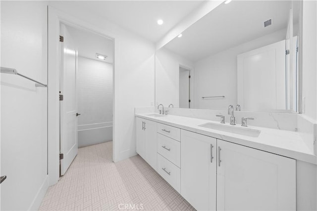 full bathroom with double vanity, visible vents, a sink, and recessed lighting