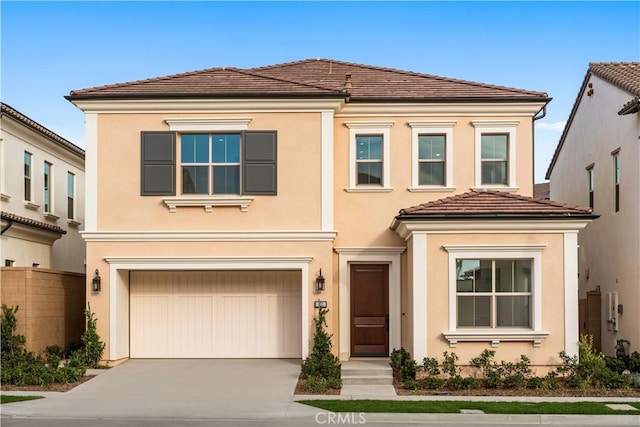 view of front of house featuring driveway, a tiled roof, and stucco siding