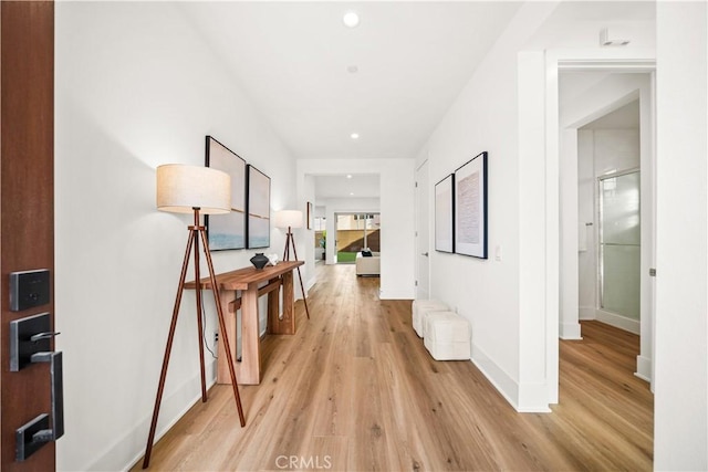 hall with light wood finished floors, recessed lighting, and baseboards