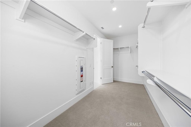 walk in closet with light carpet and visible vents